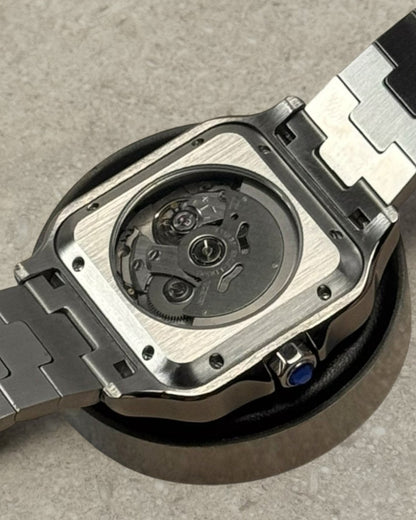 PB TimePiece Aviator Skeleton watch showing the clear case back, stainless steel bracelet, and automatic movement.