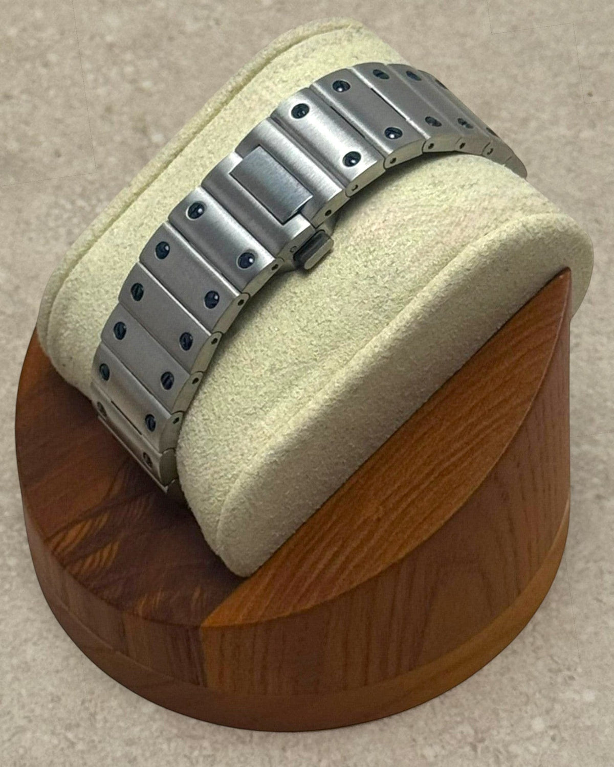 PB TimePiece Aviator watch stainless steel bracelet with butterfly clasp on a wooden display stand