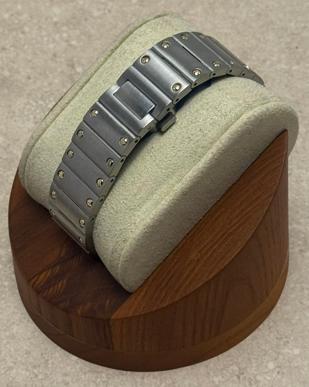 PB TimePiece Aviator watch featuring a two-tone gold and stainless steel bracelet with a butterfly clasp on a stand.