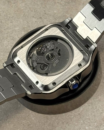 PB TimePiece Aviator watch showing the clear case back with automatic Seiko NH35 movement and stainless steel bracelet
