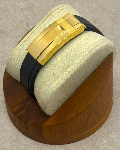 PB TimePiece Yachtmaster watch featuring a gold micro-adjusting clasp and black rubber strap on a wooden display stand