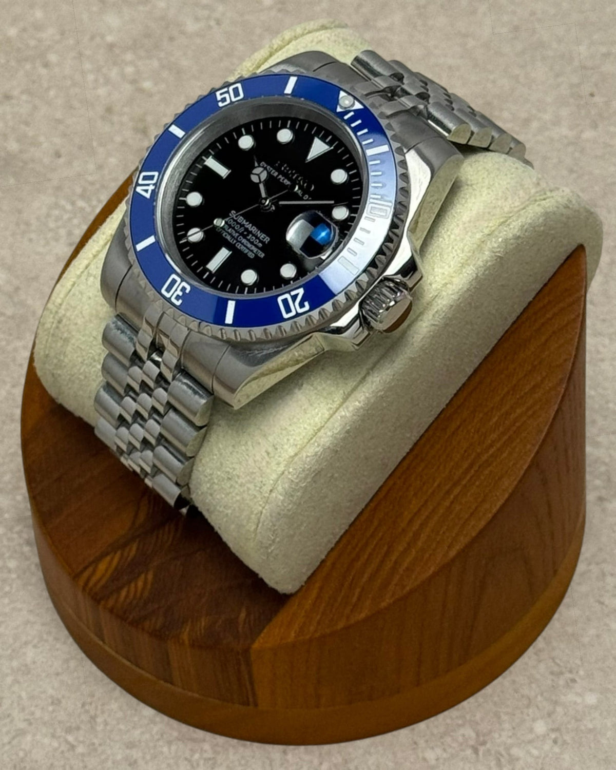 PB TimePiece Submariner Cookiemonster watch with a black dial, blue rotating bezel, and stainless steel jubilee band.