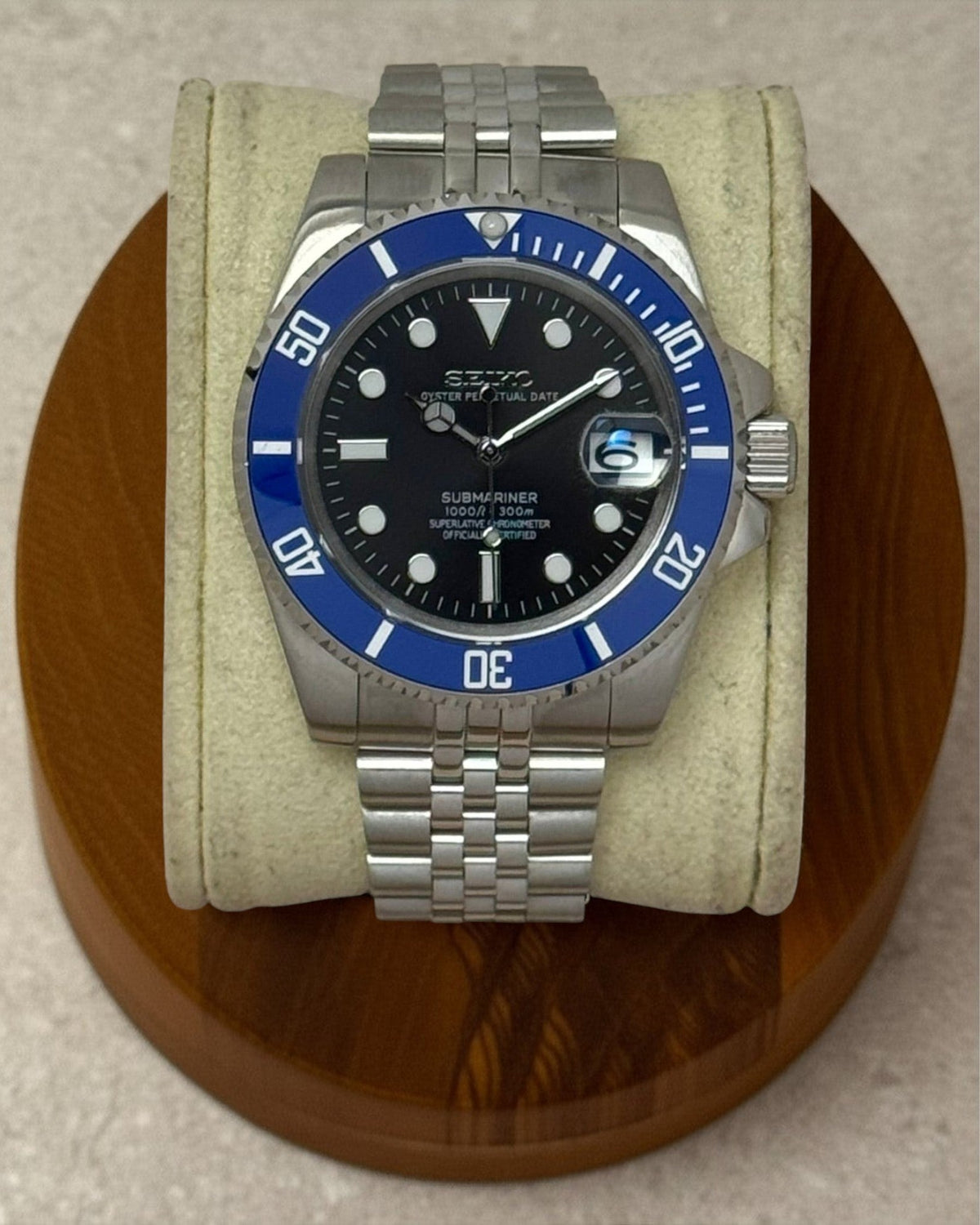 PB TimePiece Submariner Cookiemonster watch with a black dial, blue rotating bezel, and stainless steel jubilee band.
